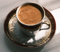 Double espresso with crema in a ceramic demitasse cup