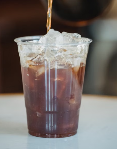 Flash-chilled black coffee served over ice in a clear glass