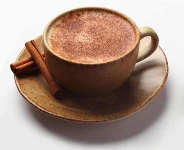 Hot chai latte with steamed milk and warm spices in a ceramic cup