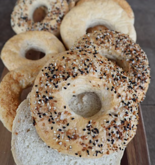 Delicious assortment of bagels with seeds, sliced and ready to enjoy.